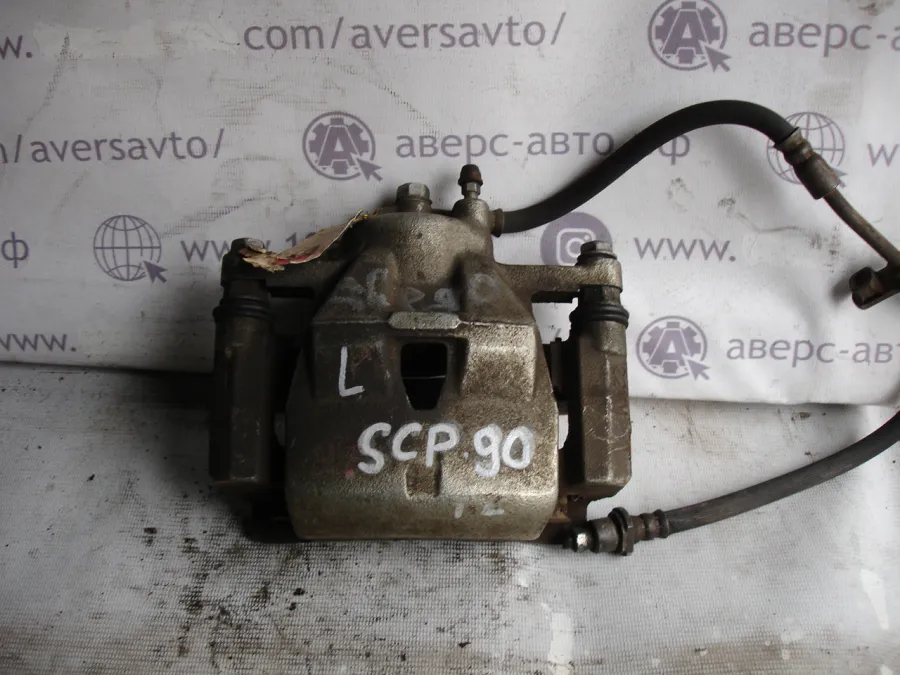 Суппорт Передний левый Toyota Vitz SCP90